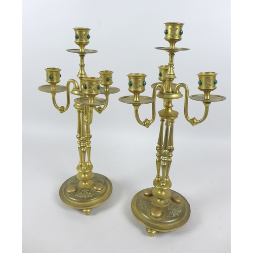 87 - A pair of mid 20th century gilt metal four branch candelabra, inlaid with malachite cabochons, each ... 