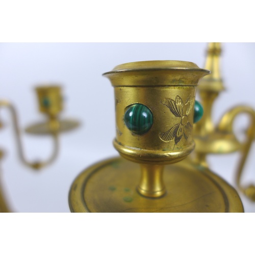 87 - A pair of mid 20th century gilt metal four branch candelabra, inlaid with malachite cabochons, each ... 