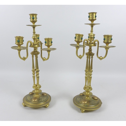 87 - A pair of mid 20th century gilt metal four branch candelabra, inlaid with malachite cabochons, each ... 