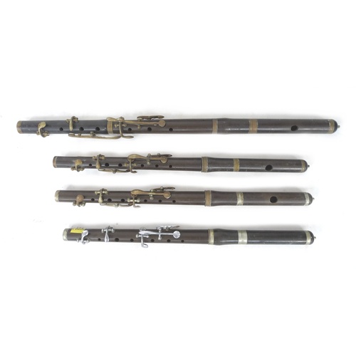 171 - A cased USA made Encore clarinet with accessories and four marching flutes, including one by Rose-Mo... 