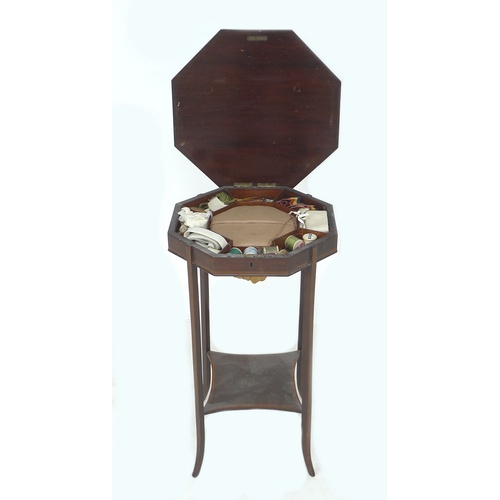 276 - An Edwardian mahogany and line inlaid sewing table, the octagonal surface lifting to reveal storage ... 