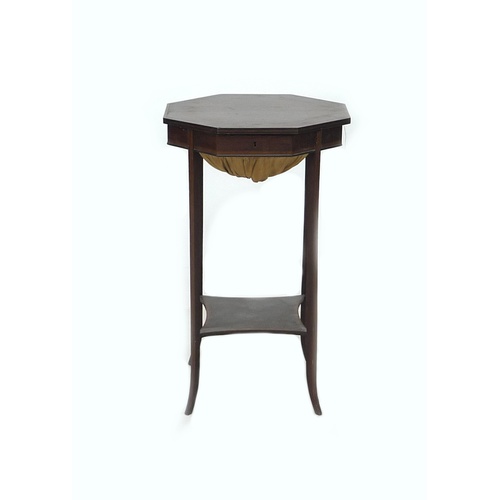 276 - An Edwardian mahogany and line inlaid sewing table, the octagonal surface lifting to reveal storage ... 