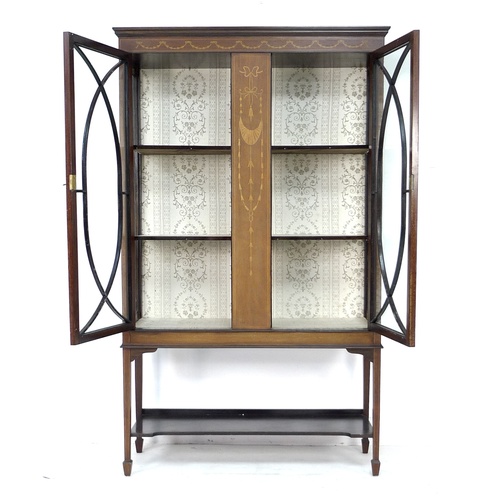 300 - An Edwardian mahogany display cabinet, with marquetry inlaid central panel flanked by twin astragal ... 