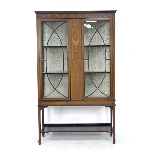 300 - An Edwardian mahogany display cabinet, with marquetry inlaid central panel flanked by twin astragal ... 