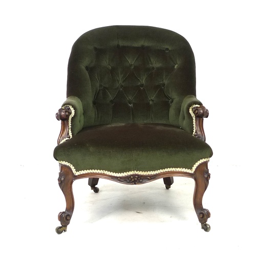 285 - A Victorian spoon back armchair, with green button back upholstery, raised upon mahogany cabriole sc... 