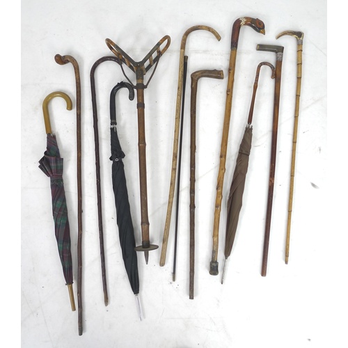 82 - A group of twelve vintage walking sticks and umbrellas, of different styles including two with silve... 