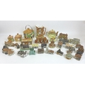 A large collection of ceramic buildings, prominently from the 'Britain in Miniature' series from the... 
