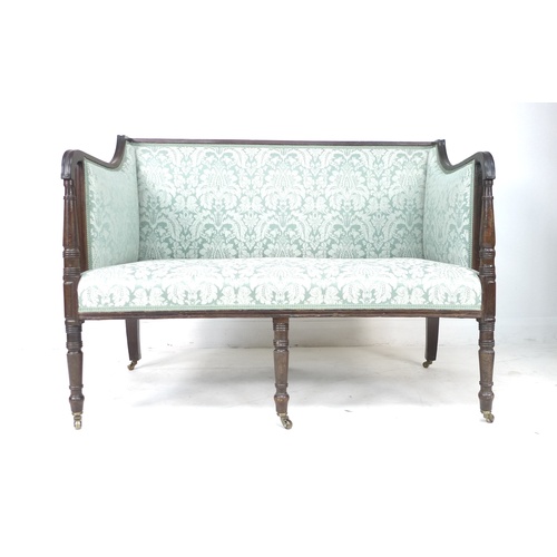 322 - A Regency mahogany framed two seater settee, with reeded decoration, raised on six turned legs with ... 