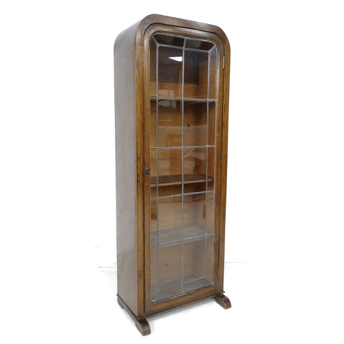 277 - An early 20th century oak bookcase, featuring an arched top, a single leaded glazed door, with curve... 