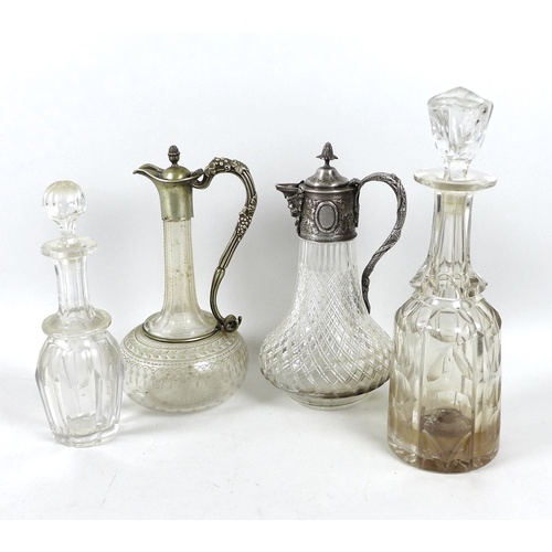 75 - A group of cut glass decanters, comprising a claret jug with silver plated mounts, fruiting vine dec... 