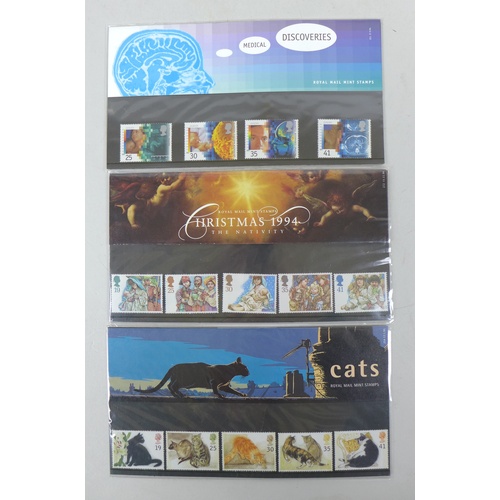 144 - A collection of Royal Mint Stamps, commemorative coins and postcards, including a limited edition, o... 