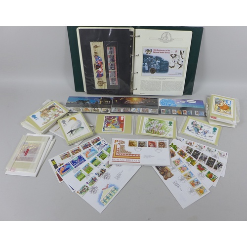 144 - A collection of Royal Mint Stamps, commemorative coins and postcards, including a limited edition, o... 