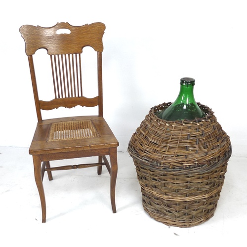 241 - An American large wicker bound green glass demijohn bottle, together with an American oak chair with... 