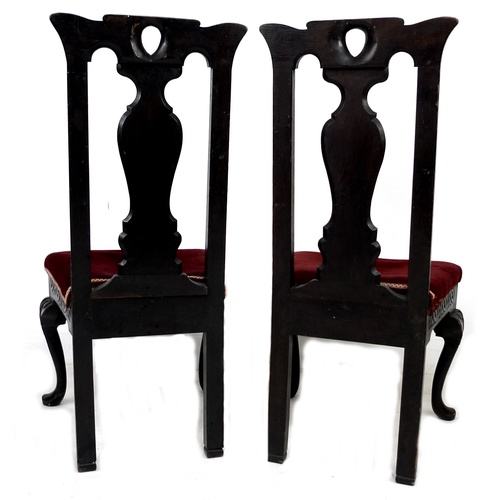 302 - A pair of late 19th century stained oak dining chairs, with poker work carved frames and splat backs... 