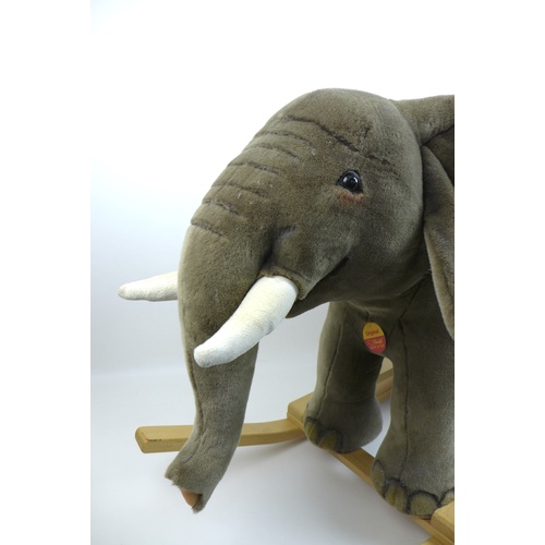 160 - A Steiff Elephant rocking toy, with wooden handles and base, without certificate, 39.5 by 108 by 65c... 