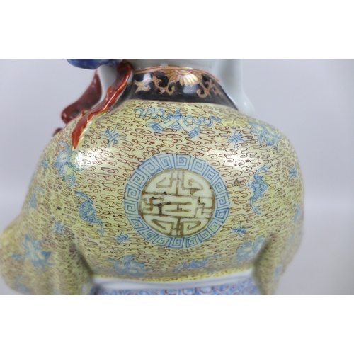 29 - A modern Chinese porcelain figure, modelled as Shou Lao, the god of longevity, standing holding a st... 