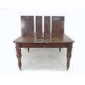 An early Victorian mahogany extending dining table, with four additional leaves, turned legs and whi... 