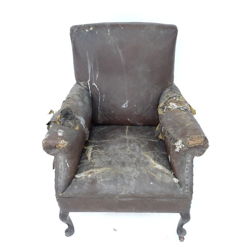 284 - An Edwardian armchair with scroll over arms, cabriole front legs and castors, 74 by 73 by 81cm high.