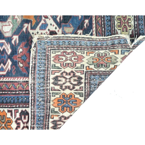 245 - A Persian Tekke rug, decorated in dark blue, white, orange and red, 170 by 130cm.