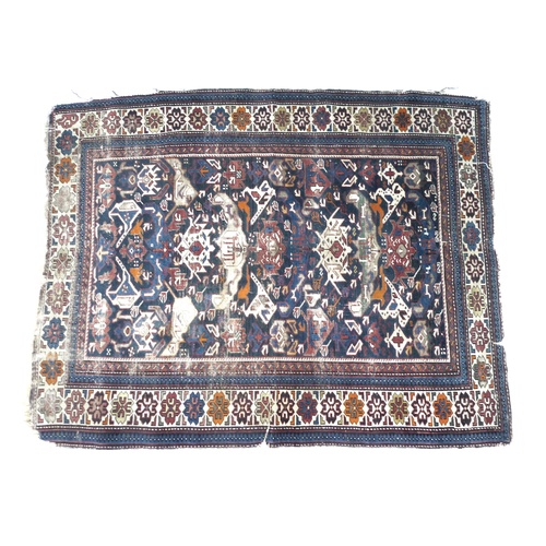 245 - A Persian Tekke rug, decorated in dark blue, white, orange and red, 170 by 130cm.