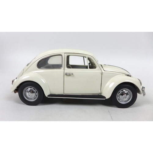 165 - A collection of six model cars, comprising Franklin Mint 1:24, 1967 Volkswagen Beetle in grey, The V... 