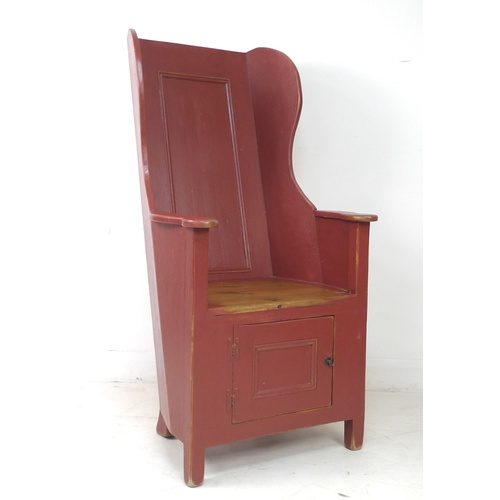 269 - A modern pine lambing chair, in 18th century style, red painted with distressed finish, cupboard to ... 