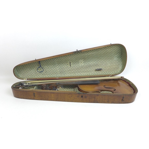 172 - An early 20th century violin, and a 19th century walnut violin coffin case, together with three viol... 