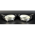 A pair of Elizabeth II silver butter dishes with matching butter knives, of oval form with with twin... 