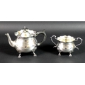 An Edward VII silver teapot and sugar bowl, of bombe form with scalloped rims, raised on four shell ... 