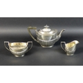 A George V three piece silver tea service, of boat form with part reeded lower bodies, each engraved... 