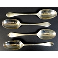 A collection of four early 18th century silver tablespoons, comprising a Queen Anne dog nose spoon, ... 