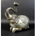 A Cambodian Khmer silver zoomorphic box, in the form of an elephant holding lotus blossom, with Tola... 