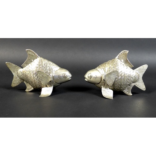 67 - A pair of Cambodian Khmer silver articulated Siamese carp, with detailed bands of scales, and movabl... 