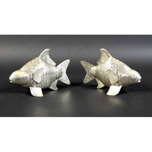 67 - A pair of Cambodian Khmer silver articulated Siamese carp, with detailed bands of scales, and movabl... 