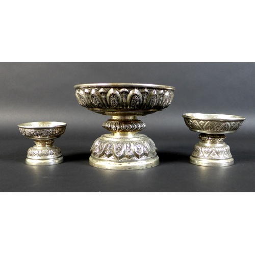 65 - A group of three graduated Cambodian Khmer silver pedestal bowls, the largest decorated with quatref... 