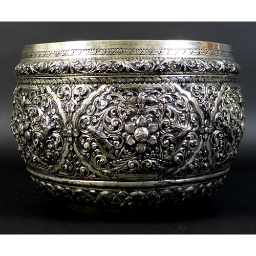 66 - An early to mid 20th century Burmese silver bowl, intricately chased and repousse work depicting scr... 