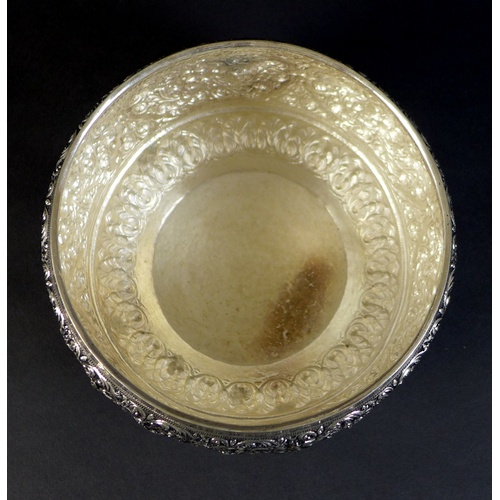 66 - An early to mid 20th century Burmese silver bowl, intricately chased and repousse work depicting scr... 