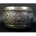 An early to mid 20th century Burmese silver bowl, intricately chased and repousse work depicting scr... 