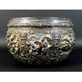 An early to mid 20th century Burmese silver bowl, intricately chased and repousse work with figural ... 