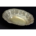 A Chinese white metal pierced bowl of oval form, with floral and foliate applied motifs, the base wi... 