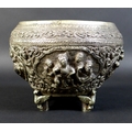 A 19th century Burmese silver Thabeik bowl, with four panels depicting mythical scenes in high relie... 