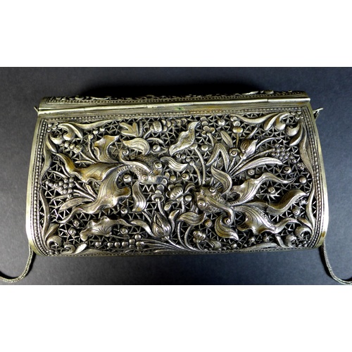 68 - An early to mid 20th century white metal purse, likely Cambodian Khmer silver, the pierced ground de... 