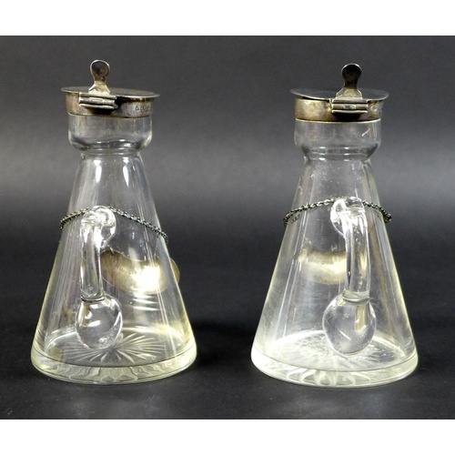 42 - A pair of Edwardian clear glass and silver mounted noggin flasks, each of tapering form with mounted... 