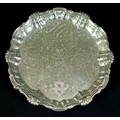 A George II silver waiter tray, of circular form with Chippendale pie crust edge, likely later chase... 