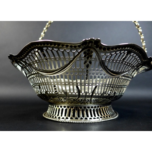 57 - A George III silver swing handled fruit basket, the pierced sides decorated with swags with harebell... 