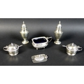 A group of five silver Victorian and Edwardian condiments, comprising a pair of Victorian urn shaped... 