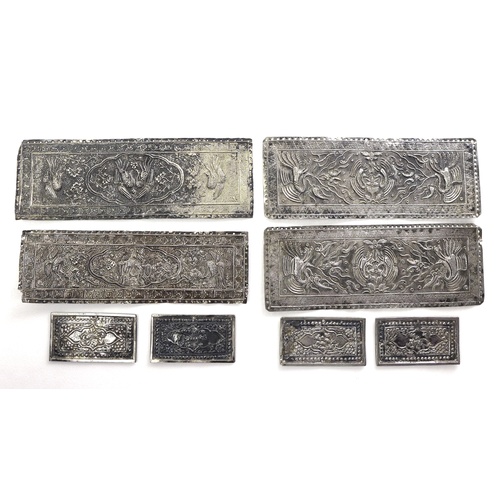 58 - A group of Chinese or South East Asian white metal book binding covers, each of rectangular form wit... 