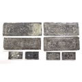 A group of Chinese or South East Asian white metal book binding covers, each of rectangular form wit... 