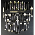 A group of silver and white metal cutlery, including five silver sugar nips, teaspoons, salt spoons,... 