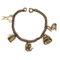 A 9ct gold charm bracelet, with five 9ct gold charms, formed as a pair of scissors, a thimble, a cof... 